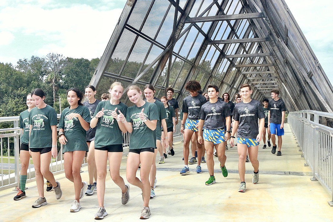 The Flagler Palm Coast High School track and field teams ran across the new pedestrian bridge and back to celebrate its grand opening. Photo by Sierra Williams